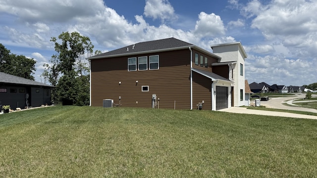 717 Angels Rest Way, Columbia, MO 65203 - back of house with a garage, concrete driveway, and a lawn