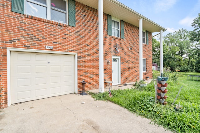 3601 W Hilltop Dr, Columbia, MO 65203 - view of side of home featuring concrete driveway, an attached garage, and brick siding