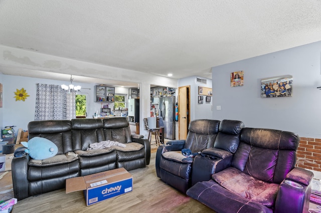 3601 W Hilltop Dr, Columbia, MO 65203 - living area with wood finished floors, a textured ceiling, and a chandelier