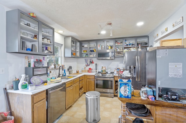 3601 W Hilltop Dr, Columbia, MO 65203 - kitchen featuring stainless steel appliances, open shelves, a textured ceiling, light countertops, and recessed lighting
