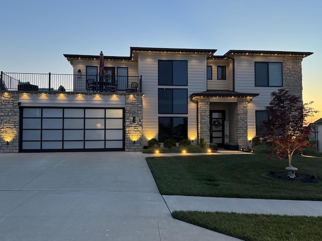 613 Red Feather Ct, Columbia, MO 65203 - contemporary house with stone siding, a balcony, and driveway