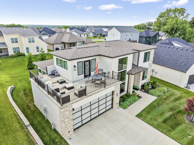 613 Red Feather Ct, Columbia, MO 65203 - view of front of property featuring a residential view, stone siding, a front lawn, a garage, and a shingled roof