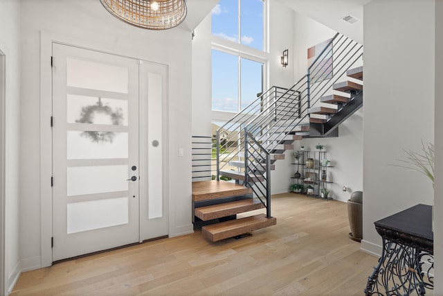 613 Red Feather Ct, Columbia, MO 65203 - entryway featuring stairway, wood finished floors, and a towering ceiling