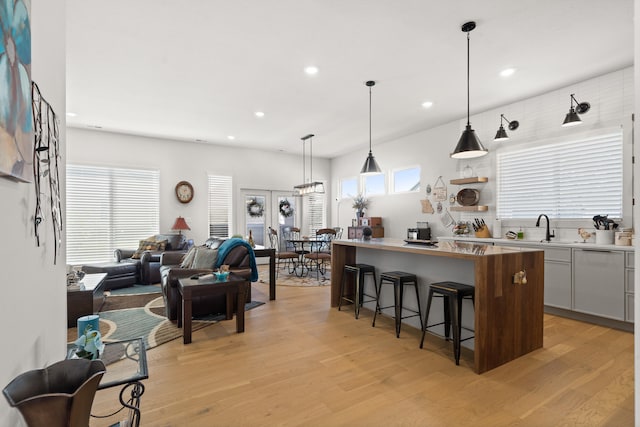 613 Red Feather Ct, Columbia, MO 65203 - kitchen featuring a kitchen bar, light wood-style floors, a center island, recessed lighting, and open floor plan