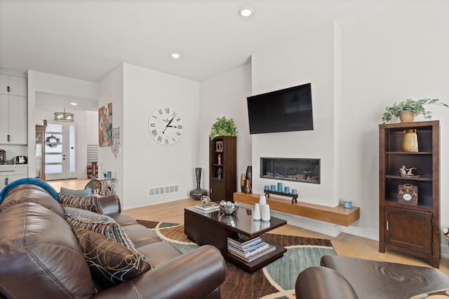 613 Red Feather Ct, Columbia, MO 65203 - living area featuring light wood-style flooring, recessed lighting, and a glass covered fireplace