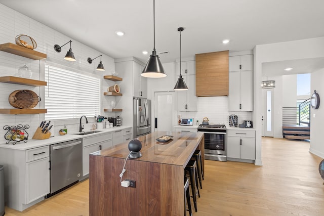 613 Red Feather Ct, Columbia, MO 65203 - kitchen with stainless steel appliances, open shelves, custom range hood, decorative backsplash, and a center island