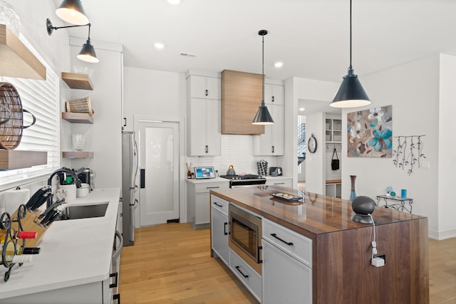 613 Red Feather Ct, Columbia, MO 65203 - kitchen with stainless steel appliances, open shelves, light wood-style flooring, a center island, and recessed lighting