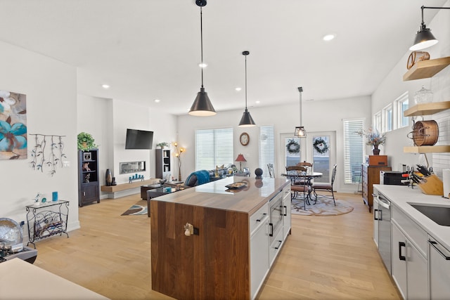 613 Red Feather Ct, Columbia, MO 65203 - kitchen with open shelves, light wood finished floors, white cabinetry, appliances with stainless steel finishes, and recessed lighting