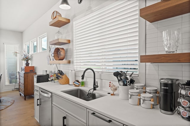 613 Red Feather Ct, Columbia, MO 65203 - kitchen with open shelves, light wood-type flooring, stainless steel dishwasher, light countertops, and backsplash