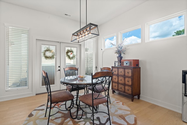 613 Red Feather Ct, Columbia, MO 65203 - dining room featuring light wood-style flooring, french doors, and a chandelier