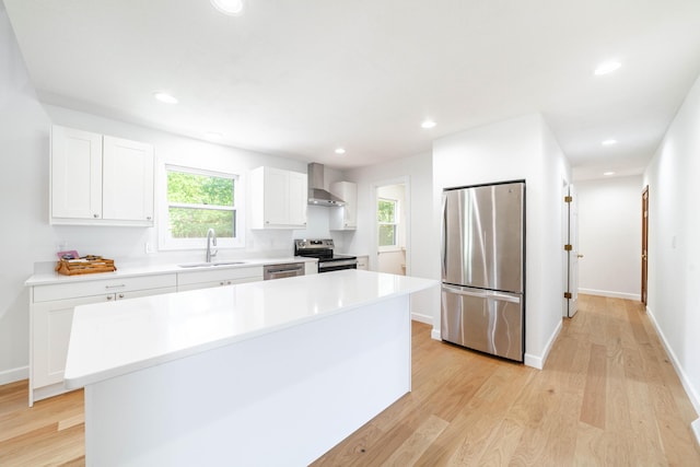 3112 Crestwood Ln, Columbia, MO 65203 - kitchen featuring appliances with stainless steel finishes, wall chimney range hood, light wood-style floors, and recessed lighting