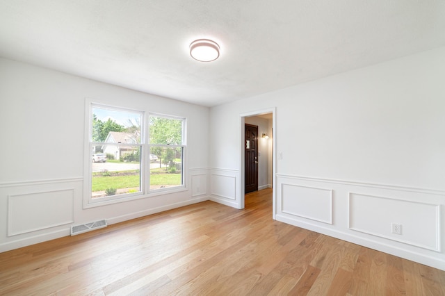 3112 Crestwood Ln, Columbia, MO 65203 - spare room with light wood-style flooring, a wainscoted wall, and a decorative wall