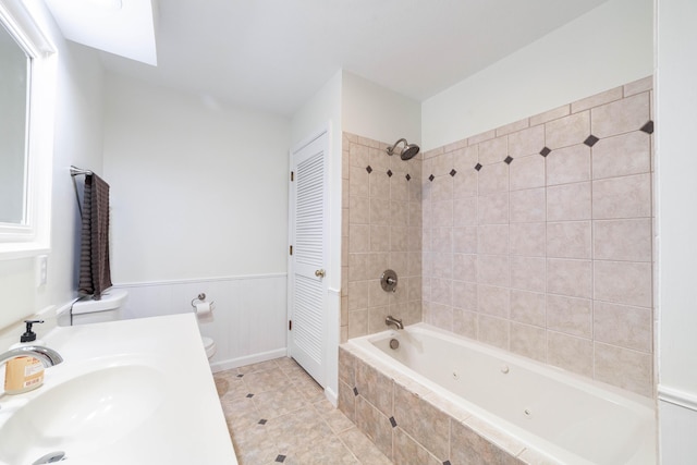 3112 Crestwood Ln, Columbia, MO 65203 - bathroom with a combined bath / shower with jetted tub, tile patterned flooring, vanity, wainscoting, and a closet