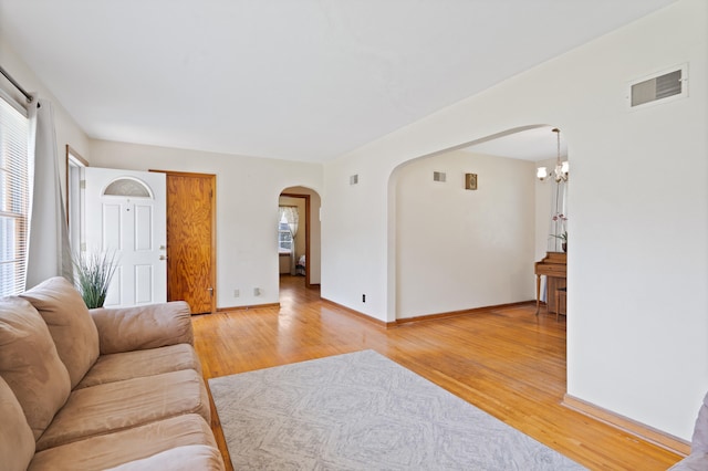 709 Clayton St, Columbia, MO 65203 - living area with arched walkways, light wood-style flooring, and healthy amount of natural light