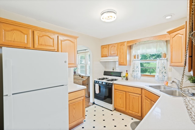 709 Clayton St, Columbia, MO 65203 - kitchen with white appliances, under cabinet range hood, light countertops, decorative backsplash, and light brown cabinets