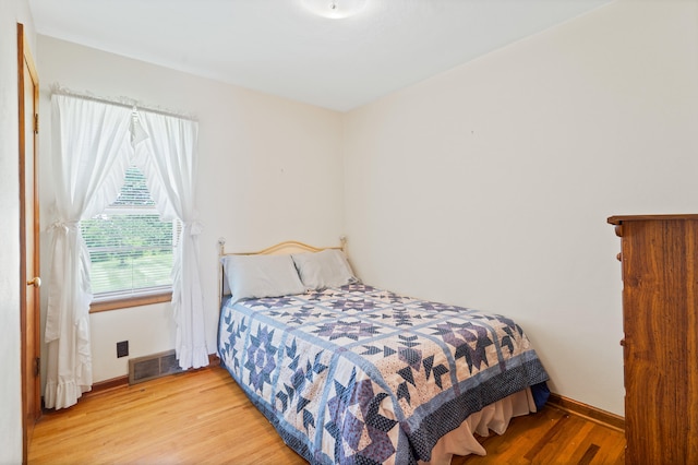 709 Clayton St, Columbia, MO 65203 - bedroom featuring light wood-type flooring and baseboards