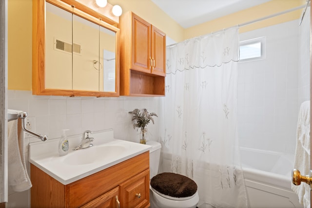 709 Clayton St, Columbia, MO 65203 - bathroom featuring vanity, shower / tub combo with curtain, tasteful backsplash, and tile walls
