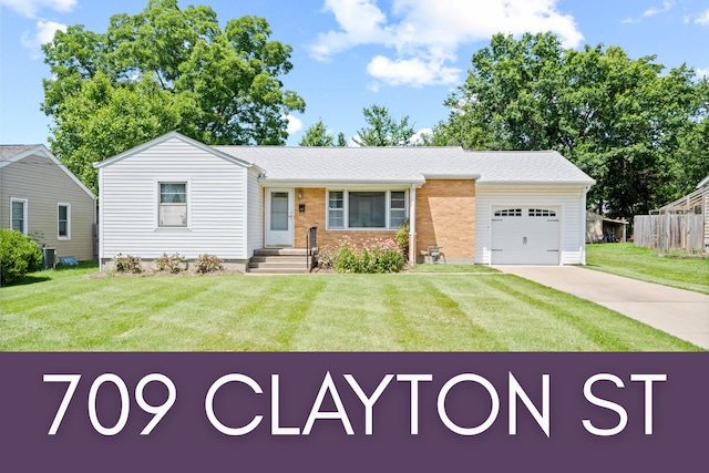 709 Clayton St, Columbia, MO 65203 - view of front of home with a garage, concrete driveway, and brick siding