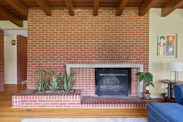 702 Russell Blvd, Columbia, MO 65203 - living room with a brick fireplace, wood finished floors, and a wood ceiling with exposed beams