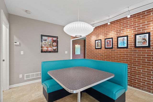 702 Russell Blvd, Columbia, MO 65203 - dining area featuring brick wall and an accent wall