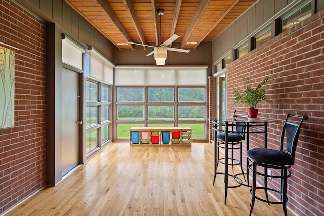702 Russell Blvd, Columbia, MO 65203 - sunroom featuring wood finished floors, a ceiling fan, a wooden ceiling with exposed beams, and brick wall