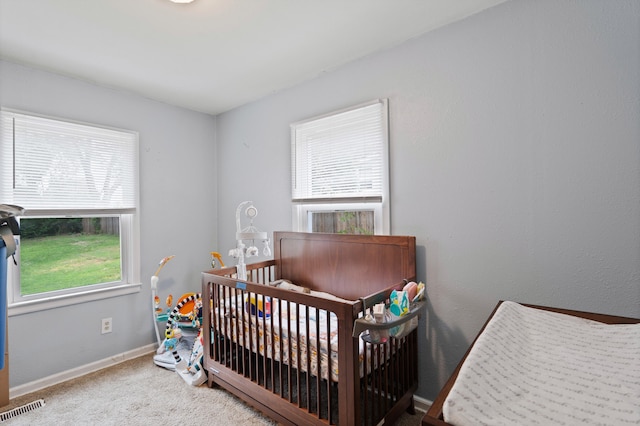 1305 Sims St, Columbia, MO 65201 - carpeted bedroom featuring a crib and baseboards