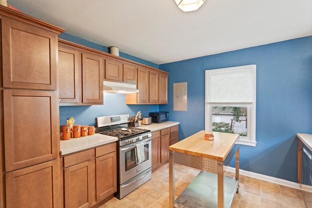 1305 Sims St, Columbia, MO 65201 - kitchen featuring stainless steel range with gas cooktop, under cabinet range hood, black microwave, light countertops, and brown cabinetry