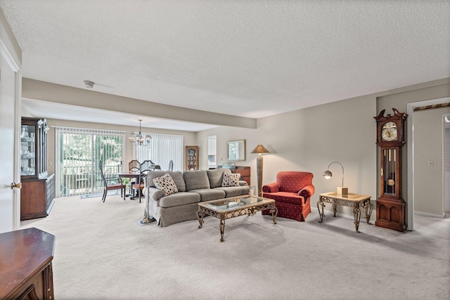 2710 Rollins Rd Unit A-1, Columbia, MO 65203 - carpeted living area featuring a chandelier and a textured ceiling
