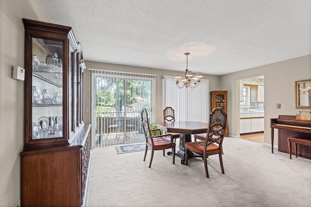 2710 Rollins Rd Unit A-1, Columbia, MO 65203 - dining area with light colored carpet, a chandelier, and a textured ceiling