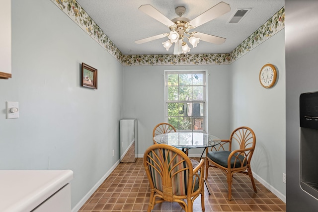 2710 Rollins Rd Unit A-1, Columbia, MO 65203 - dining room with ceiling fan and a textured ceiling