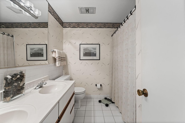 2710 Rollins Rd Unit A-1, Columbia, MO 65203 - bathroom with tile patterned flooring, double vanity, curtained shower, and wallpapered walls