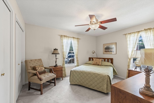 2710 Rollins Rd Unit A-1, Columbia, MO 65203 - bedroom featuring a closet, light carpet, ceiling fan, and a textured ceiling