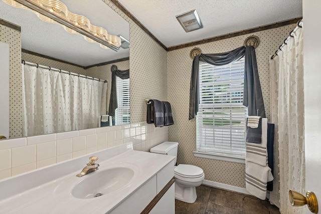 2710 Rollins Rd Unit A-1, Columbia, MO 65203 - full bathroom with vanity, wallpapered walls, plenty of natural light, ornamental molding, and a textured ceiling