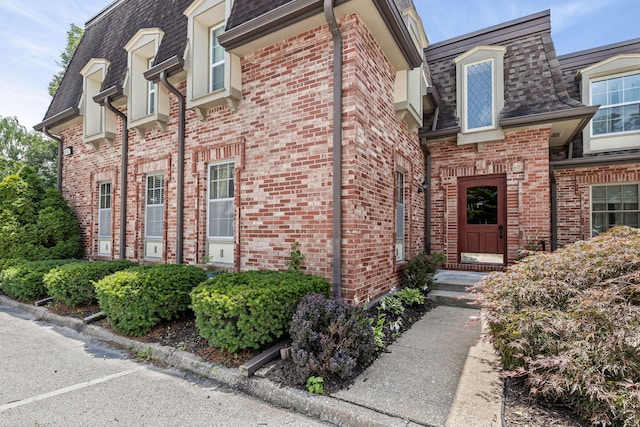 2710 Rollins Rd Unit A-1, Columbia, MO 65203 - entrance to property featuring brick siding, mansard roof, and a shingled roof