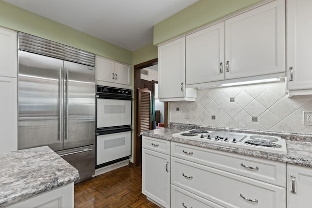 3707 Woodridge Ct, Columbia, MO 65201 - kitchen featuring white appliances, white cabinetry, backsplash, and light stone counters