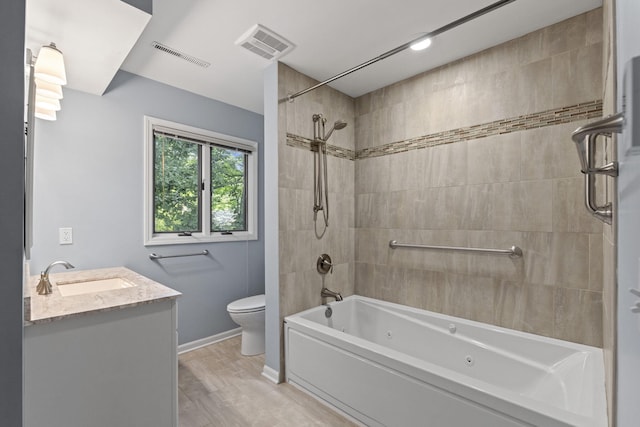 3707 Woodridge Ct, Columbia, MO 65201 - bathroom with vanity, a combined bath / shower with jetted tub, and wood finished floors
