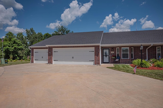 1331 Lantern Pointe Dr, Moberly, MO 65270 - view of front of house featuring brick siding, driveway, an attached garage, and roof with shingles