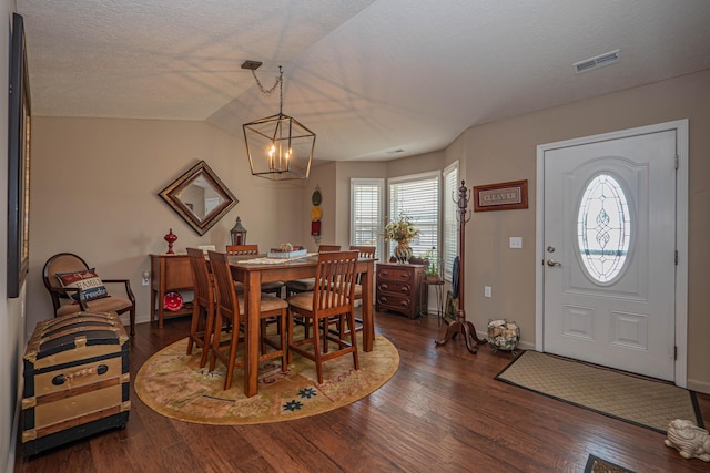 1331 Lantern Pointe Dr, Moberly, MO 65270 - dining room with a chandelier, dark wood-type flooring, and a textured ceiling