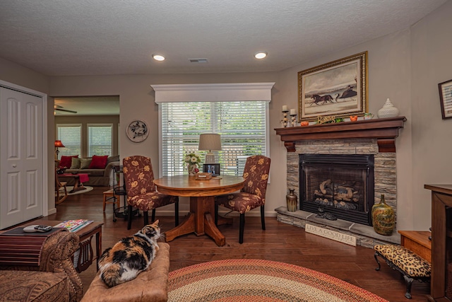 1331 Lantern Pointe Dr, Moberly, MO 65270 - dining space featuring wood-type flooring, a stone fireplace, a textured ceiling, and recessed lighting