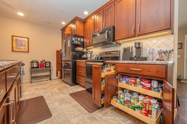 1331 Lantern Pointe Dr, Moberly, MO 65270 - kitchen with stainless steel appliances, decorative backsplash, brown cabinetry, recessed lighting, and light countertops