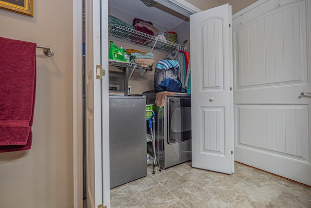 1331 Lantern Pointe Dr, Moberly, MO 65270 - laundry area featuring stone finish flooring and independent washer and dryer