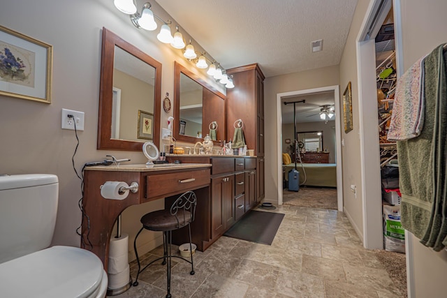 1331 Lantern Pointe Dr, Moberly, MO 65270 - bathroom with a ceiling fan, vanity, stone finish floors, and a textured ceiling