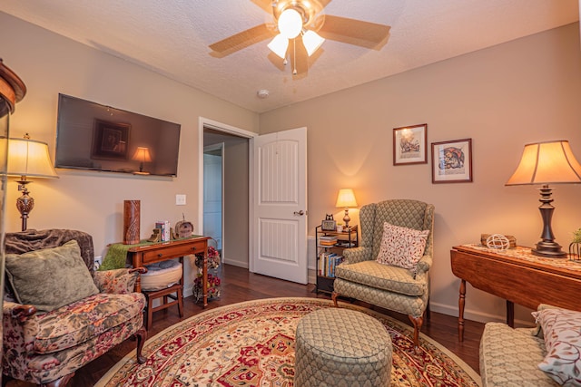 1331 Lantern Pointe Dr, Moberly, MO 65270 - living area featuring dark wood-style flooring, a ceiling fan, and a textured ceiling