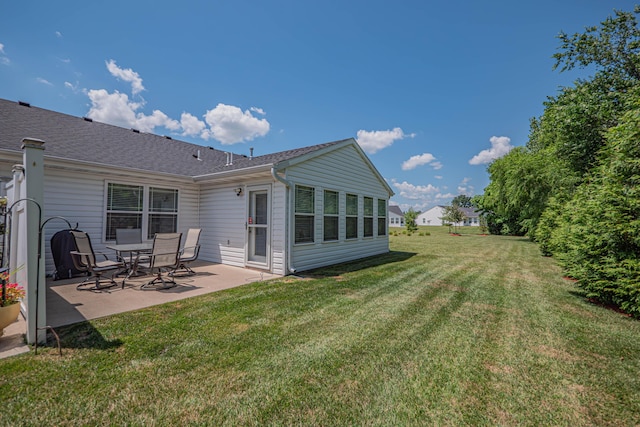 1331 Lantern Pointe Dr, Moberly, MO 65270 - back of property featuring a patio area, a lawn, and a shingled roof