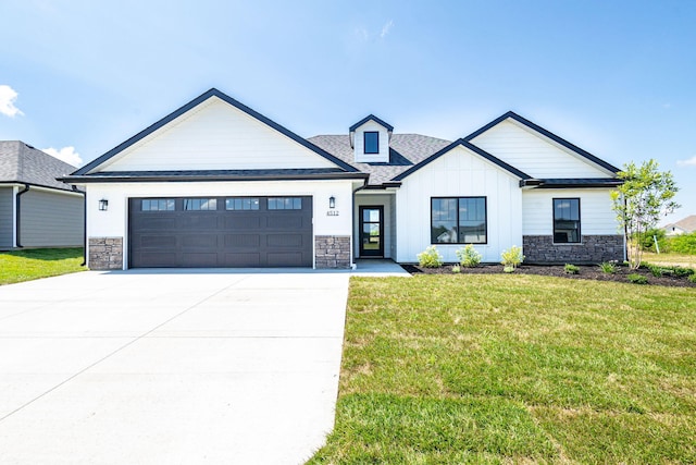 4512 Chambers Bay Dr, Columbia, MO 65201 - modern inspired farmhouse with stone siding, a garage, driveway, and a front lawn