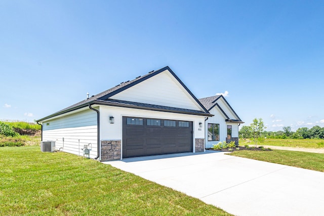 4512 Chambers Bay Dr, Columbia, MO 65201 - modern farmhouse with a front yard, concrete driveway, stone siding, and an attached garage
