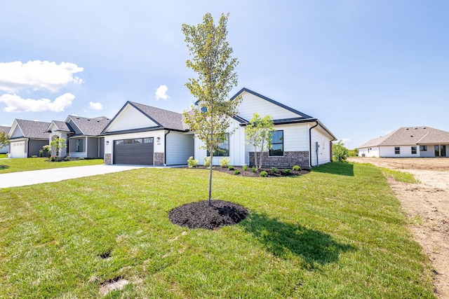 4512 Chambers Bay Dr, Columbia, MO 65201 - view of front of home with concrete driveway, a front yard, an attached garage, and stone siding