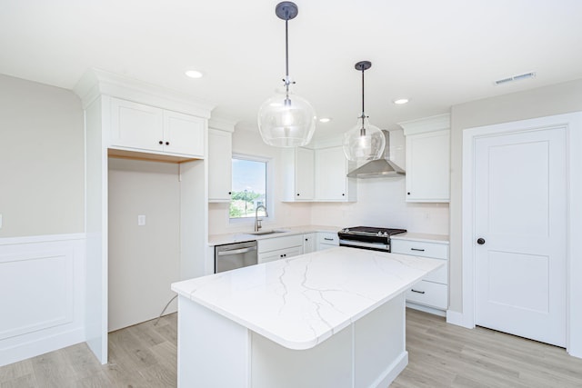 4512 Chambers Bay Dr, Columbia, MO 65201 - kitchen featuring wall chimney exhaust hood, range, stainless steel dishwasher, a kitchen island, and white cabinetry
