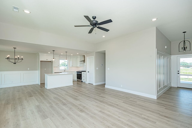 4512 Chambers Bay Dr, Columbia, MO 65201 - unfurnished living room featuring a chandelier, light wood finished floors, plenty of natural light, recessed lighting, and wainscoting