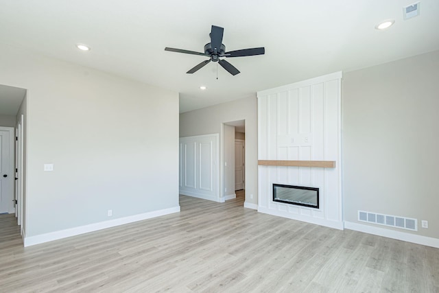 4512 Chambers Bay Dr, Columbia, MO 65201 - unfurnished living room featuring light wood-style flooring, ceiling fan, a fireplace, and recessed lighting